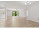 Bright living room with light wood flooring and sliding door to the outside with fan and modern light fixture at 8720 Yardley Ct # 100, Indianapolis, IN 46268