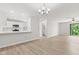 Bright living room with modern light fixture, light wood flooring and sliding door to the outside at 8720 Yardley Ct # 100, Indianapolis, IN 46268