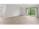 Bright living room with sliding glass doors and ceiling fan, highlighting natural light and airflow at 8720 Yardley Ct # 100, Indianapolis, IN 46268