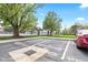 Parking lot view with reserved parking spaces and a glimpse of the pool area in the background at 8720 Yardley Ct # 100, Indianapolis, IN 46268