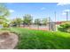 View of community tennis court, green lawn, blue sky and chain link fence at 8720 Yardley Ct # 100, Indianapolis, IN 46268