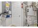 Utility room with a water heater, HVAC system, and storage at 8720 Yardley Ct # 100, Indianapolis, IN 46268