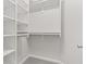 Large walk-in closet featuring built-in shelving and clothes rod at 8720 Yardley Ct # 100, Indianapolis, IN 46268