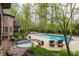 Expansive backyard featuring a pool, hot tub, and multiple seating areas, creating a luxurious outdoor living space at 9312 Sullivan Pl, Zionsville, IN 46077