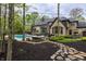 Backyard boasts a swimming pool, patio seating, a fire pit, and professionally landscaped yard at 9312 Sullivan Pl, Zionsville, IN 46077