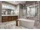 Luxurious bathroom with a freestanding tub, marble accents, glass shower, and dual vanity with stylish fixtures at 9312 Sullivan Pl, Zionsville, IN 46077