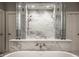 Bright bathroom features a modern glass shower with marble tile and updated bronze fixtures, complete with double doors at 9312 Sullivan Pl, Zionsville, IN 46077