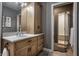 Bright bathroom featuring a wooden vanity with marble countertop and walk-in shower, offering a clean and modern design at 9312 Sullivan Pl, Zionsville, IN 46077