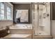 Relaxing bathroom with a soaking tub, glass shower, and neutral tones, providing a calming and spa-like experience at 9312 Sullivan Pl, Zionsville, IN 46077