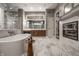 Stunning bathroom showcasing a marble freestanding tub, walk-in shower, elegant vanity, and stylish fireplace at 9312 Sullivan Pl, Zionsville, IN 46077