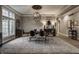 Formal dining room featuring an elegant chandelier, decorative columns, and a large window with outdoor views at 9312 Sullivan Pl, Zionsville, IN 46077