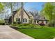 Beautiful stone house surrounded by trees and lush landscape provides privacy and curb appeal at 9312 Sullivan Pl, Zionsville, IN 46077