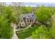 Stunning stone home with mature trees, lush landscaping, and a winding walkway at 9312 Sullivan Pl, Zionsville, IN 46077