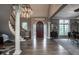 Grand foyer featuring a curved staircase, hardwood floors, and elegant chandelier at 9312 Sullivan Pl, Zionsville, IN 46077