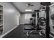 Well-equipped home gym featuring weightlifting equipment, treadmill, and rubber flooring for a comprehensive workout space at 9312 Sullivan Pl, Zionsville, IN 46077