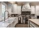 Bright kitchen with stainless steel appliances, a farmhouse sink, and ample counter space at 9312 Sullivan Pl, Zionsville, IN 46077