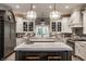 Bright kitchen with a large island, pendant lighting, and white custom cabinets at 9312 Sullivan Pl, Zionsville, IN 46077