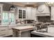 Modern kitchen featuring stainless steel appliances, marble countertops, and custom cabinetry at 9312 Sullivan Pl, Zionsville, IN 46077