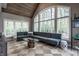 Spacious living room featuring a sectional sofa, high ceilings, and large windows with serene outdoor views at 9312 Sullivan Pl, Zionsville, IN 46077