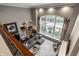 Open-concept living room with tall ceilings, oversized windows, and natural light, perfect for entertaining guests at 9312 Sullivan Pl, Zionsville, IN 46077