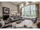 Bright living room with large window, comfortable seating, and elegant decor at 9312 Sullivan Pl, Zionsville, IN 46077