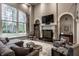 Sophisticated living room boasting a fireplace, large window, and cozy seating arrangement at 9312 Sullivan Pl, Zionsville, IN 46077