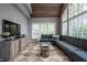 Comfortable living room with a blue sectional, decorative glass coffee table, and plenty of natural light at 9312 Sullivan Pl, Zionsville, IN 46077