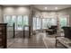 Elegant living room featuring hardwood floors, large windows, and a cozy seating area, perfect for relaxing at 9312 Sullivan Pl, Zionsville, IN 46077