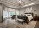 Luxury main bedroom suite featuring a tray ceiling, a leather bed frame, and plenty of natural light at 9312 Sullivan Pl, Zionsville, IN 46077