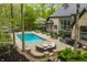 Inviting backyard with a pool, hot tub, outdoor seating, and landscaped patio area at 9312 Sullivan Pl, Zionsville, IN 46077