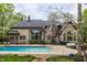 A sparkling pool, patio and plush seating surrounded by professional landscaping in a private backyard at 9312 Sullivan Pl, Zionsville, IN 46077
