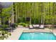 Inviting pool and patio area with comfortable seating, professionally landscaped yard and mature trees at 9312 Sullivan Pl, Zionsville, IN 46077