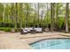 Outdoor patio area with comfortable seating around a pool, ideal for relaxation and enjoying the serene natural surroundings at 9312 Sullivan Pl, Zionsville, IN 46077