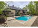 Spacious backyard includes a swimming pool with diving board, lounge chairs and shade trees at 9312 Sullivan Pl, Zionsville, IN 46077