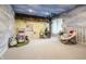 Playful room with muraled walls, faux tree, custom play house facade, and cozy seating area at 9312 Sullivan Pl, Zionsville, IN 46077