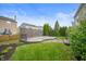 A well-manicured backyard featuring a multi-level deck with privacy screens and lush green grass at 9454 W Canoe Trl, Pendleton, IN 46064