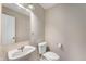 Powder room with pedestal sink and toilet in a neutral color scheme at 9454 W Canoe Trl, Pendleton, IN 46064