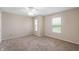 Carpeted bedroom with a ceiling fan and sunlit windows, providing a peaceful and well-lit environment at 9454 W Canoe Trl, Pendleton, IN 46064