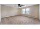 Inviting bedroom features plush carpeting, a ceiling fan, and sunlit windows at 9454 W Canoe Trl, Pendleton, IN 46064