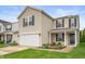 Charming two-story home boasts a two-car garage, driveway, well-kept lawn, and pleasant curb appeal at 9454 W Canoe Trl, Pendleton, IN 46064