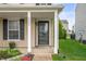 Inviting front porch features classic columns and a stylish storm door at 9454 W Canoe Trl, Pendleton, IN 46064