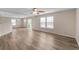 The bright living room features new flooring, a ceiling fan, and access to the backyard at 9454 W Canoe Trl, Pendleton, IN 46064