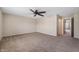 Large carpeted main bedroom with ceiling fan and an open doorway, creating a serene and inviting space at 9454 W Canoe Trl, Pendleton, IN 46064
