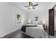 Serene bedroom features a comfortable bed, ceiling fan, and natural light from two windows at 997 Yandes St, Franklin, IN 46131