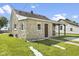 Stone house featuring a covered side porch and well-maintained green lawn at 997 Yandes St, Franklin, IN 46131