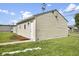 Back of the detached garage with neutral siding and green grass at 997 Yandes St, Franklin, IN 46131