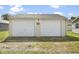 Detached two car garage with white doors and siding on gravel at 997 Yandes St, Franklin, IN 46131