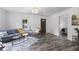 Sunlit living room features modern décor, hardwood floors, and an open doorway to bedroom at 997 Yandes St, Franklin, IN 46131