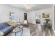 Cozy living room features hardwood floors, a decorative light fixture, and an open doorway to bedroom at 997 Yandes St, Franklin, IN 46131