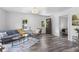 Bright living room with a modern light fixture, stylish furniture, and open doorway to bedroom at 997 Yandes St, Franklin, IN 46131
